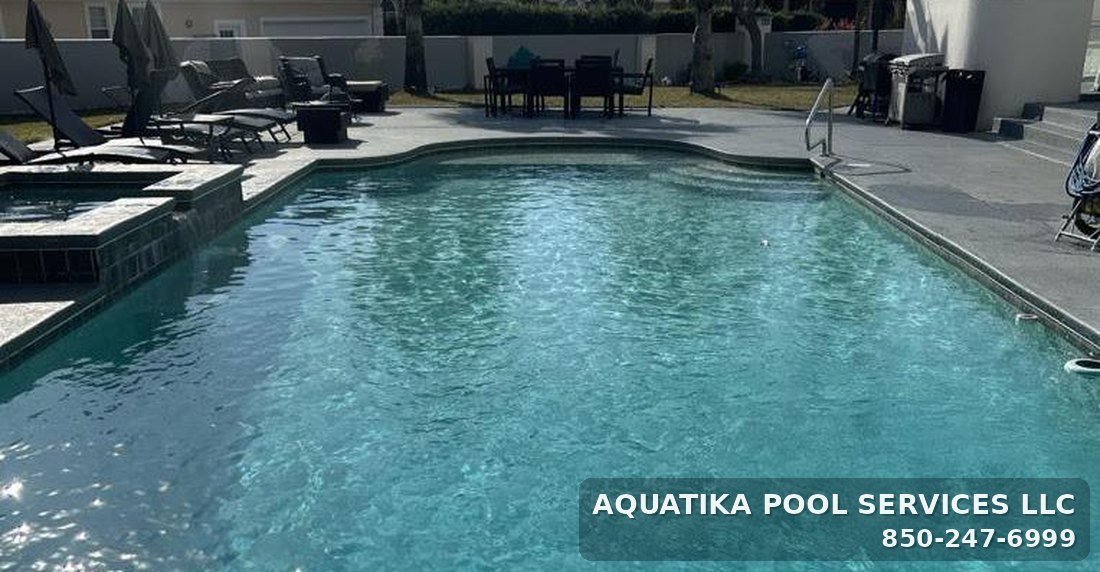 Large inground pool with attached spa maintained by Aquatika Pool Services in Bay County, Florida